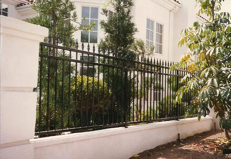Wrought Iron Property Fence on Top of Block Wall